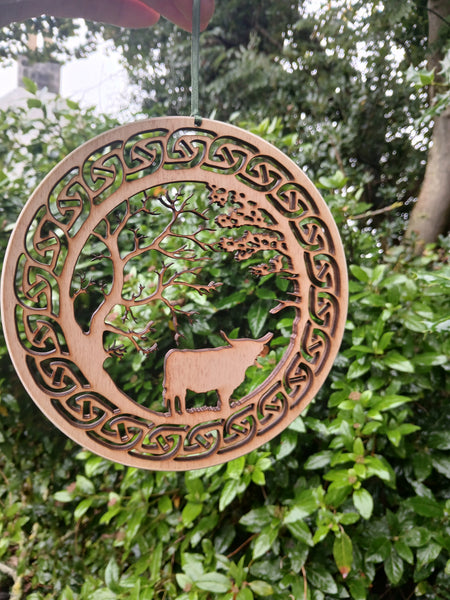 Hanging of Highland Cow under Trees with Celtic Knot border