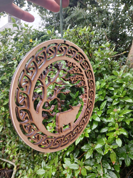 Hanging of Highland Cow under Trees with Celtic Knot border