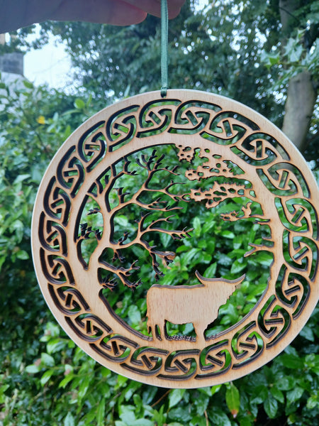 Hanging of Highland Cow under Trees with Celtic Knot border