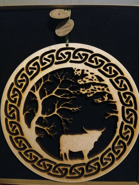 Hanging of Highland Cow under Trees with Celtic Knot border