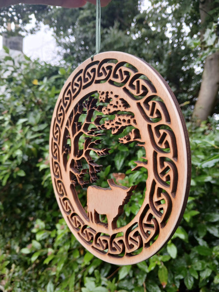 Hanging of Highland Cow under Trees with Celtic Knot border